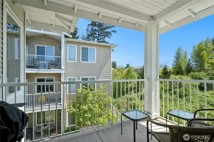 Enjoy the view of the green belt from the covered deck.