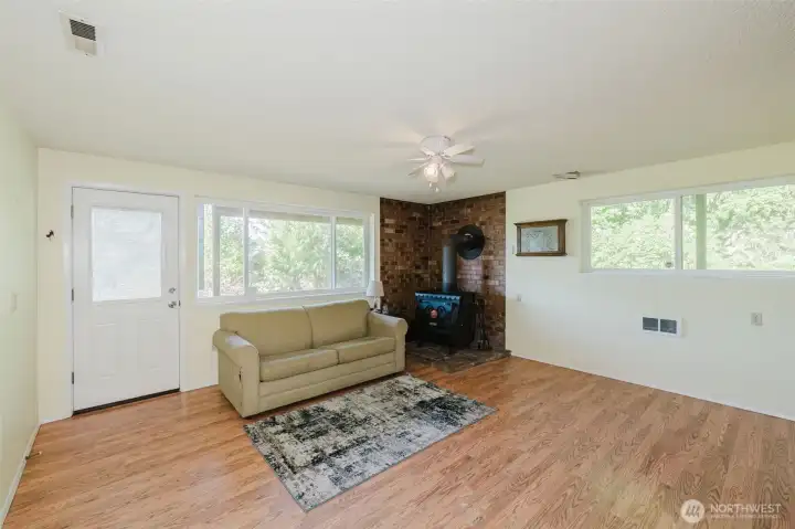 Family room with wood stove and exterior / separate door