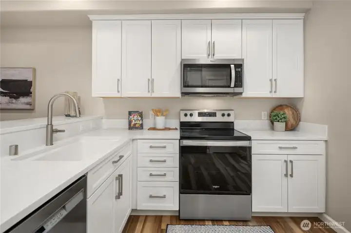 Stunning completely remodeled kitchen with high-end custom cabinets, quartz countertops and a gorgeous Kohler cast iron sink.