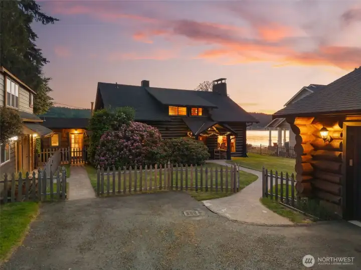 A twilight shot of this magical property. Main log home in the center, ADU on the left and Rec Hall on the right.