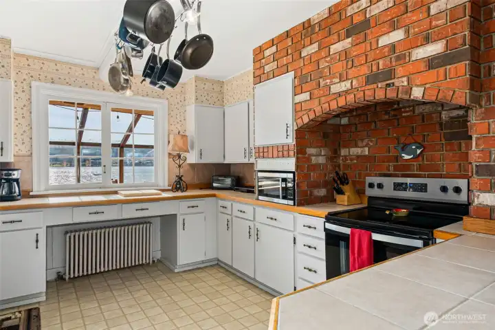 Warm and  inviting kitchen with plenty of storage and updated appliances. There is even a water veiw!