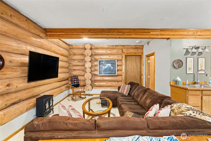 Living room area of pool hall. Closed door comes from garage. Open door is the full bath.
