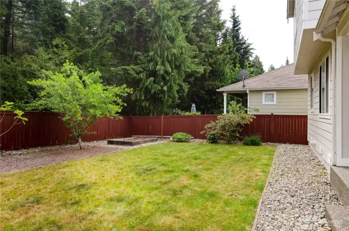 Level back fully fenced yard with garden space.
