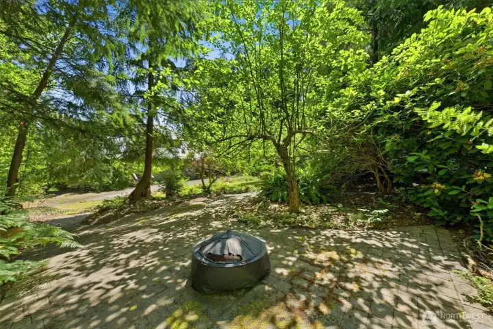 Covered firepit near the front of the house