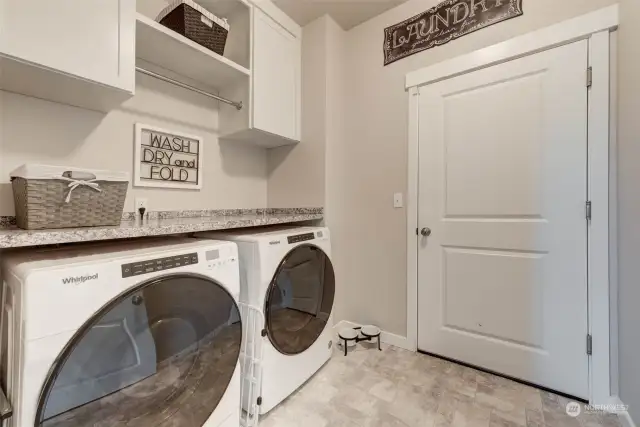 The laundry room has ample cabinets AND you'll appreciate the tankless water heater in the garage...