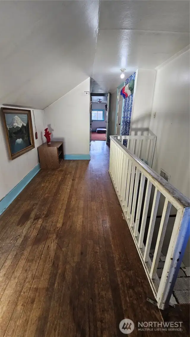 top of stair rail looking down upstairs hall