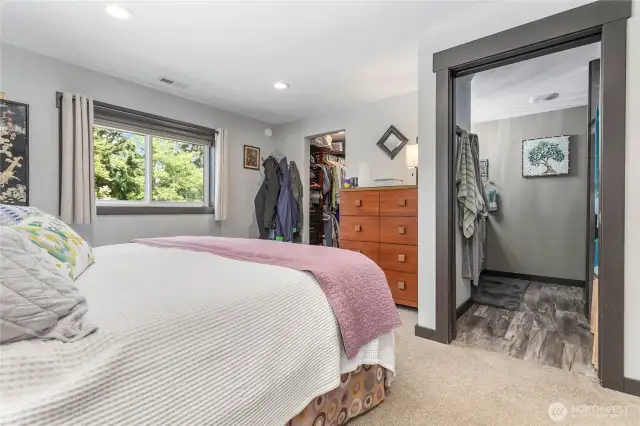 View of entry into the primary bathroom and walk-in closet