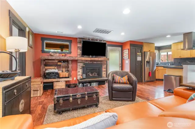 Cozy newer gas fireplace. The door to the backyard has inset blinds.