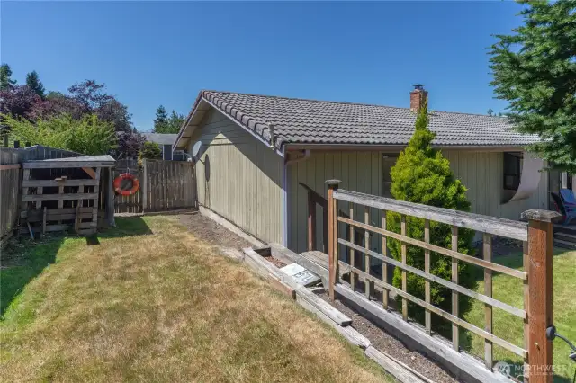 Side yard with wood shed and more room for plants.