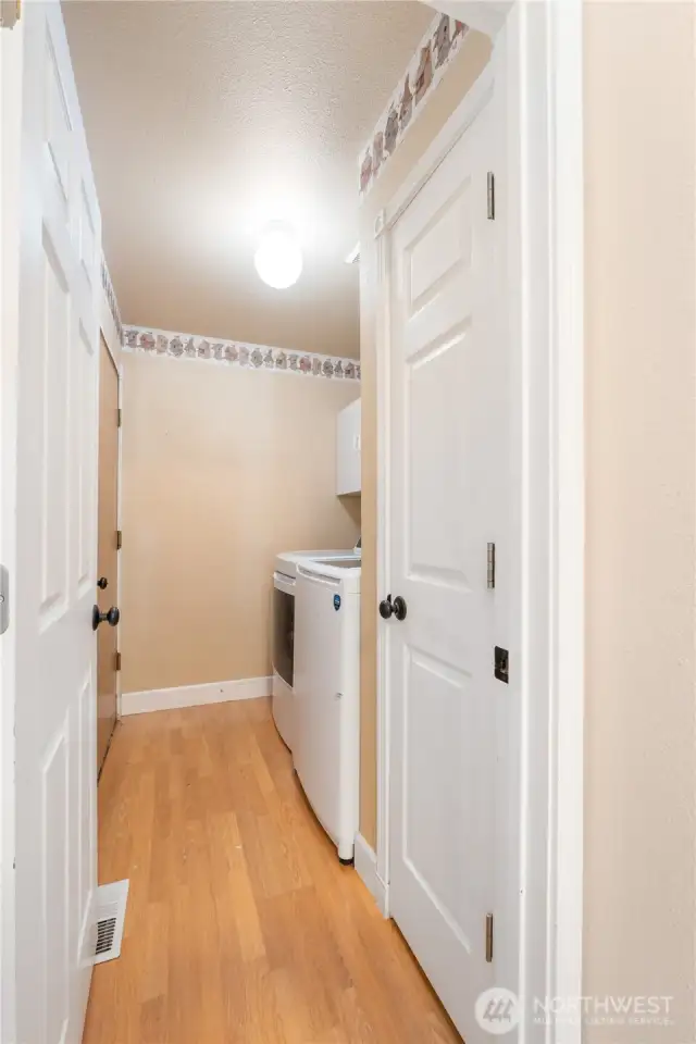 Laundry room with door to attached two car garage