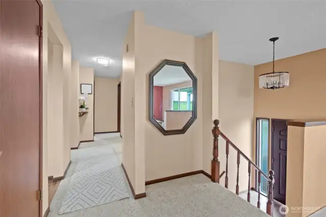 Upstairs hall with stairs to front door.