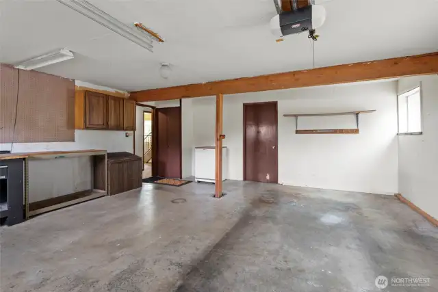 Attached one car garage. The door to the right leads into a large utility room and more storage.