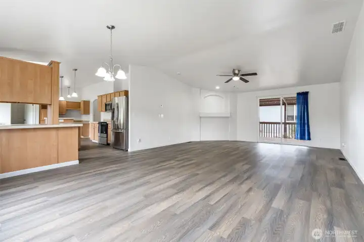 Large open living room with slider to covered deck.