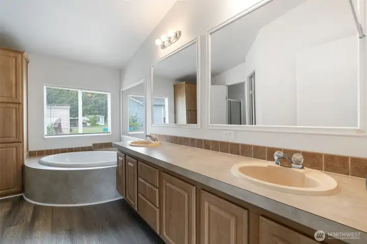 Soaker tub and double vanity in the primary bath.