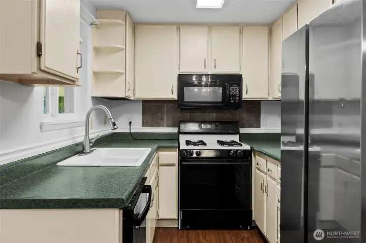 Kitchen view shows you how much storage is packed into this space! And the refrigerator is included!