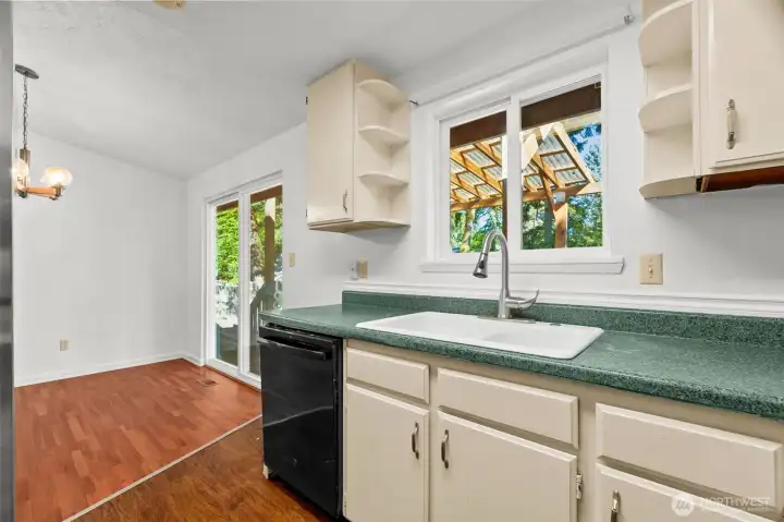 Kitchen looking toward dining area and sliding glass doors to rear covered deck