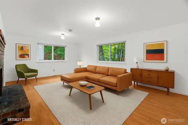 Family room (virtually staged) features an amazing wood burning fireplace, easy access to garage, and tons of natural light--gorgeous!
