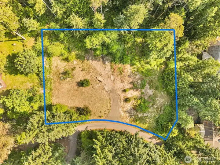 Partially cleared and corners marked.