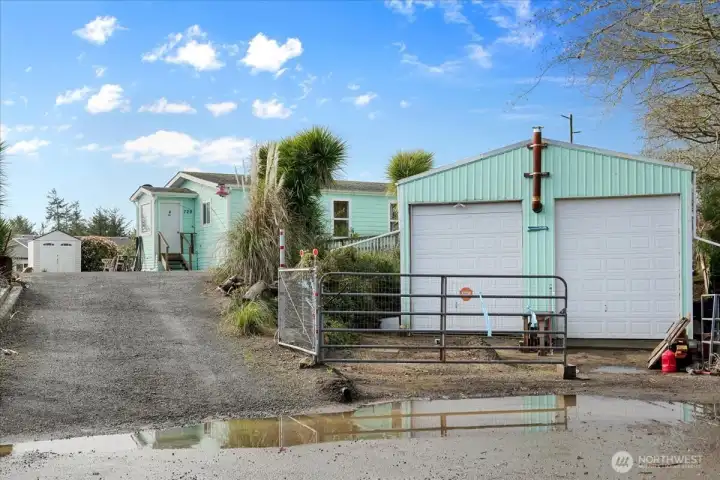 Street view of home and shop with loft and room for RV storage.