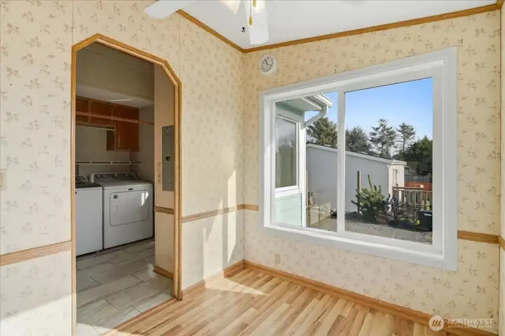 View of breakfast nook and utility room from kitchen.