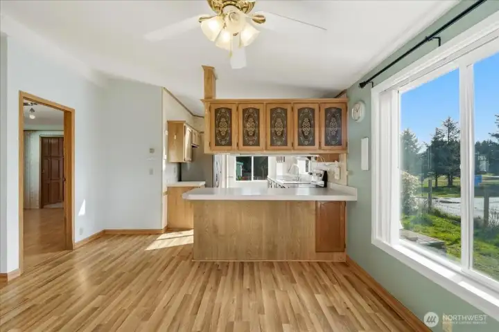 View of kitchen and primary bedroom from dining area.