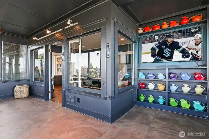 There is a TV nook in the Sun Room!  It's a great place to relax and watch your favorite team!  This angle looks back into the dining room.