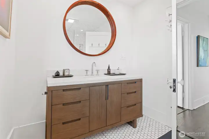 This modern 3/4 bathroom is located on the second floor. Recently renovated with new flooring, a stylish vanity with a Quartz countertop and a beautiful new shower enclosure.