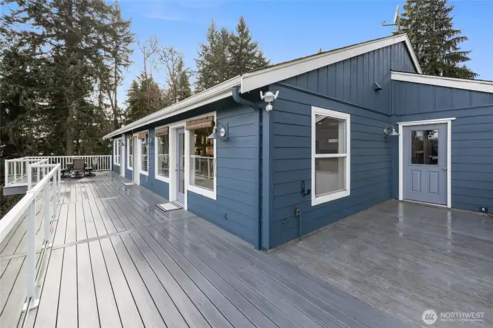 Large composite deck for easy maintenance. The door to the right is access to the 2 car garage.