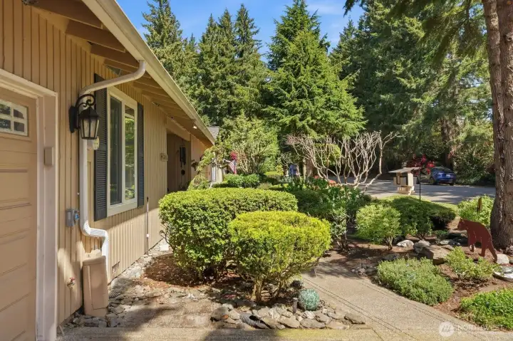 A lush, manicured landscape and private walkway lead you to this impeccably maintained single-level home.