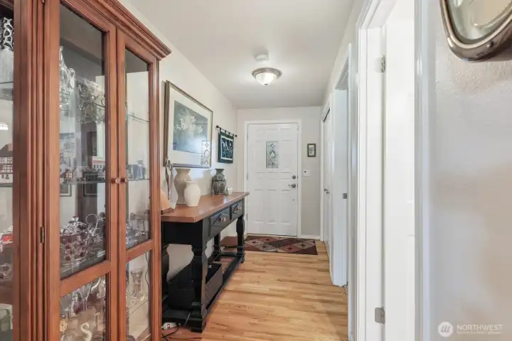 The wide entry hallway highlights the home’s open feel and high-end finishes from the moment you step inside.
