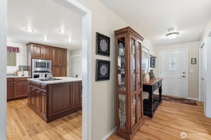 Hardwood flooring and updated lighting in the hall set a sophisticated tone for the rest of the residence.
