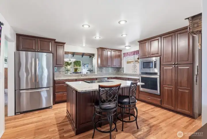 Elegant hardwood floors lead the way from the entry into the heart of the home.