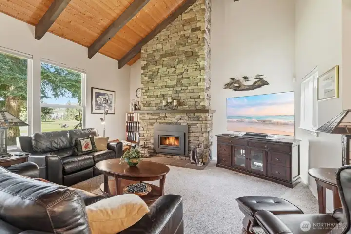 The newer stacked-stone gas fireplace serves as a stunning floor-to-ceiling focal point.