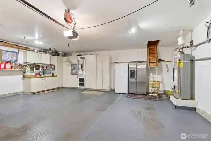 The oversized two-car garage provides plenty of room for vehicles and a workshop area.