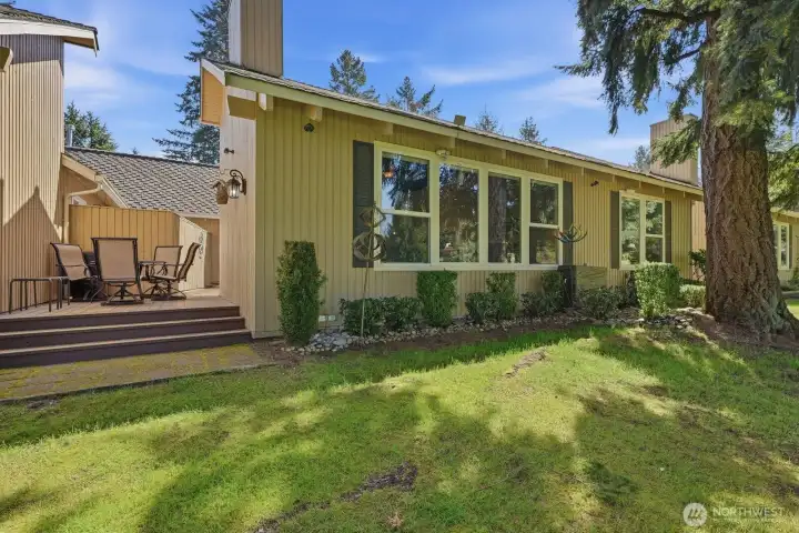 The rear elevation showcases the recently painted deck and the home’s prime, unobstructed position on the 5th Fairway.