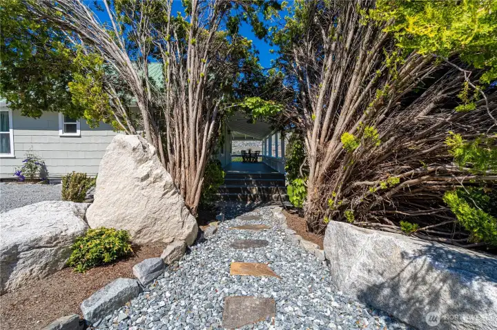 Junipers create a canopy to front entrance.