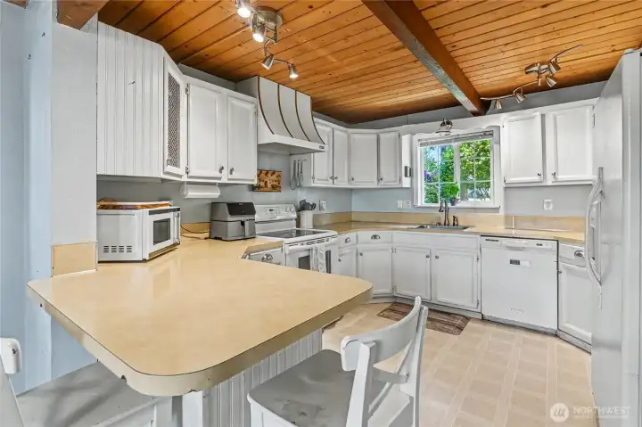 Kitchen features a breakfast bar.