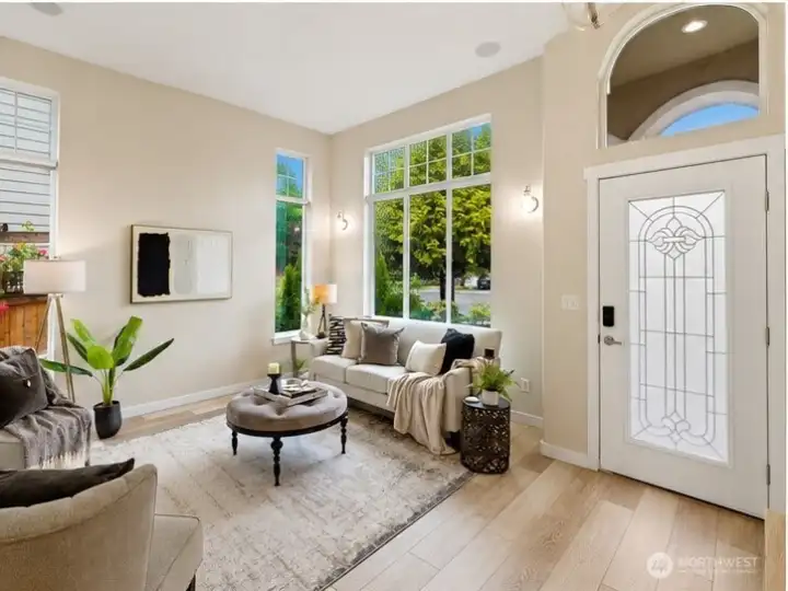 Expansive living room windows enhance the home’s open feel, bringing in abundant natural light. Expansive living room windows enhance the home’s open feel, bringing in abundant natural light.
