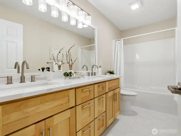 Spacious upper-level bath featuring dual vanities and generous counter space. Spacious upper-level bath featuring dual vanities and generous counter space.