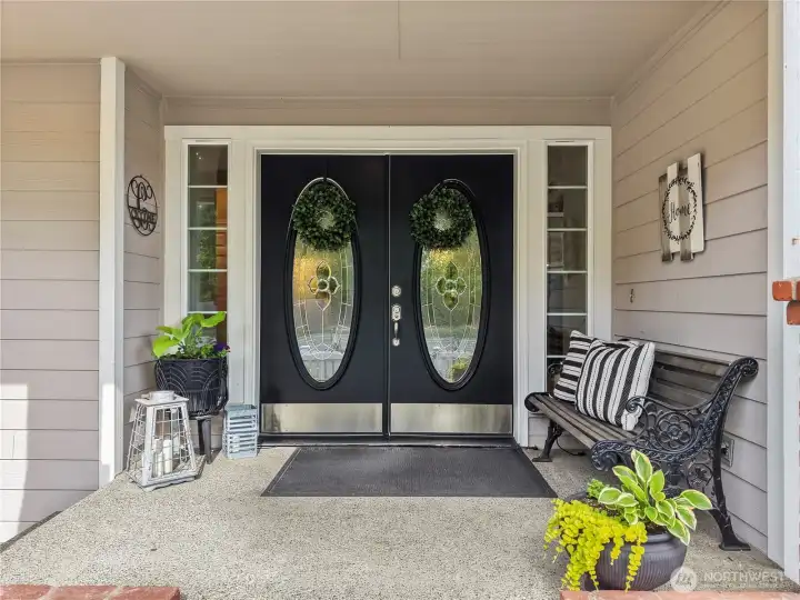 Inviting double door entry & expansive covered front porch sets the tone for the impressive interior beyond.