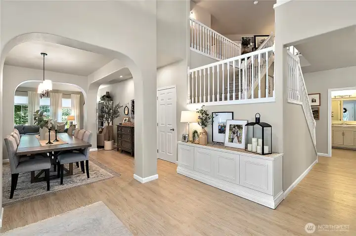 Soaring ceilings, graceful archways, and a sweeping staircase makes for a stunning first impression upon entry.