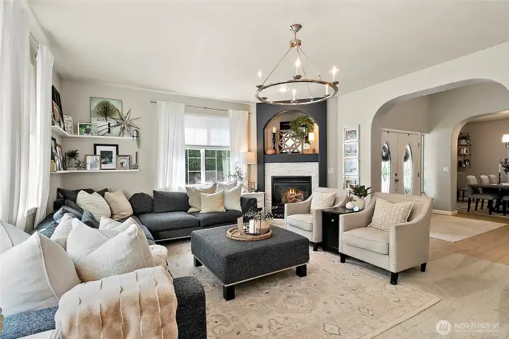 Inviting living room features a cozy gas fireplace with updates tile surround, and a niche above!