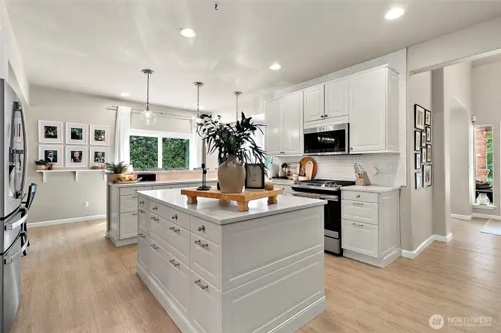 Large center island offers abundant storage and anchors the spacious, flowing kitchen.