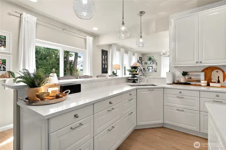 Custom cabinetry conceals both the dishwasher & garbage/recycle.