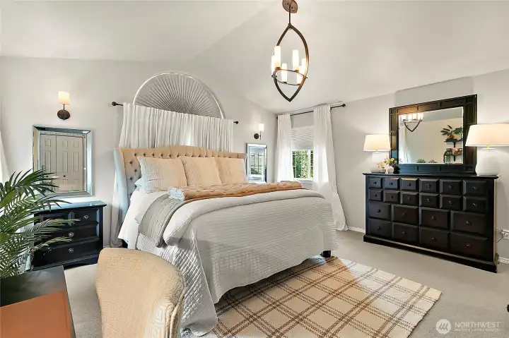 Spacious primary suite features vaulted ceilings, a luxurious 5-piece bath, walk-in closet, and an additional closet for even more storage.