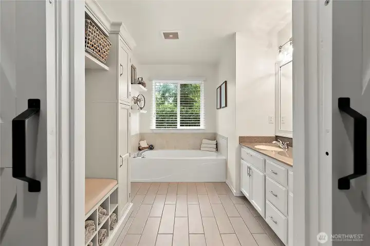 Retreat to a beautifully updated primary ensuite, complete with barn door entry and thoughtfully selected finishes throughout including a jetted tub!