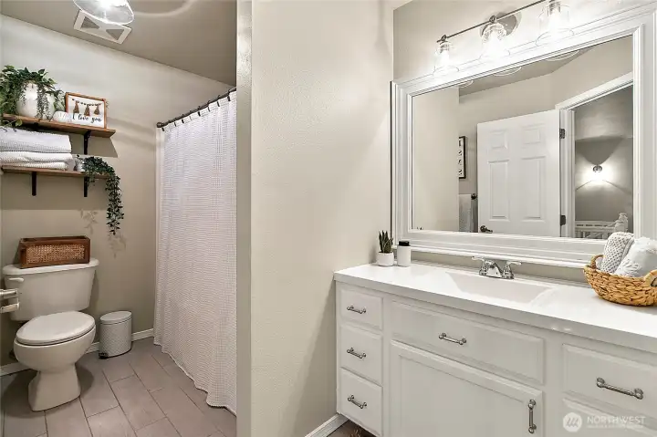 Well appointed full bathroom with updated finishes, centrally located among the bedrooms.