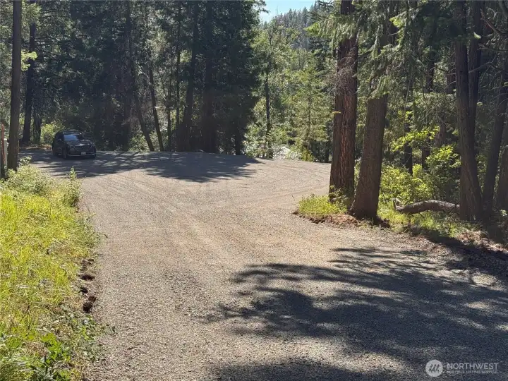 This shows you the view coming into the building site, the car in the corner shows size.  Beyond the car is a proposed well site & more level acreage.l