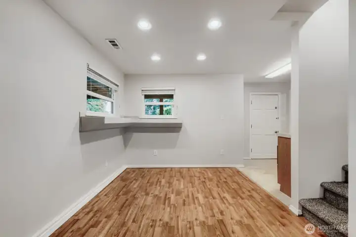 Adjacent to the second kitchen on the lower level is this cheery dining space, complete with views to the backyard.