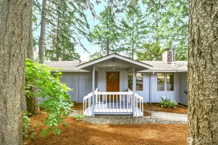 A welcoming covered front porch, towering evergreens and layers of native Pacific Northwest landscaping on this almost-1/3 of an acre create an inviting first impression that's as peaceful as it is practical. The portrait-style windows are one of my favorite architectural details, offering a wonderful mid-century nod while perfectly complementing the home's Northwest Contemporary design. River rock borders, fresh bark and decorative rain chains quietly reinforce that connection to nature, while the winding walkway hints that there's much more waiting just around the corner. A welcoming covered front porch, towering evergreens and layers of native Pacific Northwest landscaping on this almost-1/3 of an acre create an inviting first impression that's as peaceful as it is practical. The portrait-style windows are one of my favorite architectural details, offering a wonderful mid-century nod while perfectly complementing the home's Northwest Contemporary design. River rock borders, fresh bark and decorative rain chains quietly reinforce that connection to nature, while the winding walkway hints that there's much more waiting just around the corner.